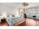 Serene main bedroom with bay windows, hardwood floors, ceiling fan, and seating area at 2971 Fort Matanzas Ter, Henderson, NV 89052