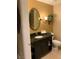 Bathroom with black cabinets, decorative mirror, and tile floor at 30 Strada Di Villaggio # 439, Henderson, NV 89011