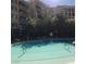 Community pool with surrounding buildings and lounge chairs, perfect for relaxation at 30 Strada Di Villaggio # 439, Henderson, NV 89011