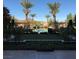 View of the community pool with palms and manicured landscaping and green space at 30 Strada Di Villaggio # 439, Henderson, NV 89011