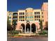 Beautiful condo building featuring balconies, a fountain, arched entry, and manicured landscaping at 30 Strada Di Villaggio # 439, Henderson, NV 89011