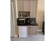 Functional kitchenette featuring a microwave, sink, and mini-fridge for a convenient refreshment area at 30 Strada Di Villaggio # 439, Henderson, NV 89011