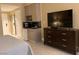 A neatly designed room with a kitchenette, dresser, and TV, offering comfortable living at 30 Strada Di Villaggio # 439, Henderson, NV 89011