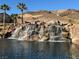 Scenic water feature with waterfall, palm trees and natural rock outcroppings at 30 Strada Di Villaggio # 439, Henderson, NV 89011