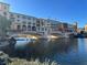 Scenic view of a waterfront property with architectural arches and reflections in the water at 30 Strada Di Villaggio # 439, Henderson, NV 89011