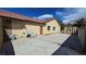 Home exterior featuring a paved backyard with a storage shed and access door at 3407 Bristlecone St, Las Vegas, NV 89146