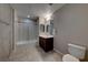 Bathroom showcasing a tub, glass shower, large mirror, and modern sink at 353 E Bonneville Ave # 125, Las Vegas, NV 89101