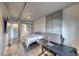 Bedroom with concrete accents, a tv, a desk, a large window, and modern design at 353 E Bonneville Ave # 125, Las Vegas, NV 89101
