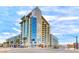 Exterior view of the modern building featuring multiple stories, balconies, and stylish design at 353 E Bonneville Ave # 125, Las Vegas, NV 89101