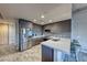 Modern kitchen features stainless steel appliances, stylish cabinets, and a quartz countertop bar with seating at 353 E Bonneville Ave # 125, Las Vegas, NV 89101