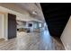 Stylish living room with a modern kitchen, industrial staircase, and wood-look tile throughout the living space at 353 E Bonneville Ave # 125, Las Vegas, NV 89101