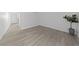 Unfurnished bedroom featuring light wood-look flooring and white walls at 3597 Arville St # 201B, Las Vegas, NV 89103