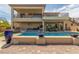 Backyard with pool, spa, outdoor kitchen and beautiful landscaping for relaxation and entertainment at 386 Cactus River Ct, Henderson, NV 89052