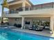 Stunning outdoor living area with a pool, spa, covered patio, and lounge seating at 386 Cactus River Ct, Henderson, NV 89052