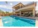 Expansive backyard showcasing a luxurious pool, spa, and outdoor living area at 386 Cactus River Ct, Henderson, NV 89052