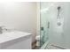 Updated bathroom featuring white vanity, a glass shower, and stone floors at 386 Cactus River Ct, Henderson, NV 89052