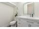 Bathroom featuring a white vanity with a quartz countertop, decorative mirror, and fixtures at 386 Cactus River Ct, Henderson, NV 89052