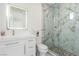 Bathroom featuring a marble walk-in shower and a white vanity with an illuminated mirror at 386 Cactus River Ct, Henderson, NV 89052
