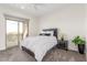 Cozy bedroom with a black headboard, a nightstand, and a view of the outdoors at 386 Cactus River Ct, Henderson, NV 89052