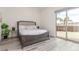Bright bedroom featuring a large bed, wood floors, and sliding glass doors to a patio at 386 Cactus River Ct, Henderson, NV 89052