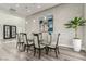 Dining room with modern glass table, seating for six, and elegant artwork at 386 Cactus River Ct, Henderson, NV 89052