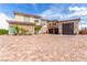 Stunning exterior with brick driveway, stone accents, a three car garage, and a private balcony at 386 Cactus River Ct, Henderson, NV 89052