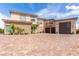 Stunning exterior with brick driveway, stone accents, a three car garage, and a private balcony at 386 Cactus River Ct, Henderson, NV 89052