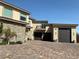 Modern home with a multi-car garage, stone accents, and a brick-paved driveway at 386 Cactus River Ct, Henderson, NV 89052