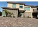 Beautiful home featuring stone accents, large windows, and a brick-paved driveway at 386 Cactus River Ct, Henderson, NV 89052