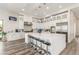 Modern kitchen with sleek white cabinets, stainless steel appliances, and a spacious center island with seating at 386 Cactus River Ct, Henderson, NV 89052
