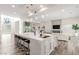 Open-concept living space featuring a modern kitchen with a large island and a comfortable living area at 386 Cactus River Ct, Henderson, NV 89052