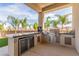 Outdoor kitchen with built-in grill, refrigeration, and counter space, perfect for entertaining at 386 Cactus River Ct, Henderson, NV 89052