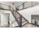 Modern staircase featuring a black metal railing and white walls with wood flooring at 386 Cactus River Ct, Henderson, NV 89052