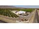 Aerial view of an orchard, showcasing rows of trees and farm buildings at 3925 Kettle Falls Ave, North Las Vegas, NV 89085