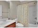 Bathroom featuring a shower/tub combo, wood cabinet vanity, and ducky theme shower curtain at 3925 Kettle Falls Ave, North Las Vegas, NV 89085