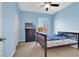 This cozy bedroom features blue walls, a ceiling fan, and a bright window view at 3925 Kettle Falls Ave, North Las Vegas, NV 89085