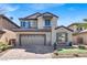 Charming two-story home featuring a two-car garage, complemented by a beautifully designed front yard and desert landscaping at 3925 Kettle Falls Ave, North Las Vegas, NV 89085