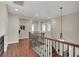 Upstairs hallway with wood floors, wrought iron railing, and decorative accents at 3925 Kettle Falls Ave, North Las Vegas, NV 89085