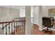Upstairs hallway featuring wood floors, iron railing and view of a home office at 3925 Kettle Falls Ave, North Las Vegas, NV 89085
