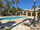 Community pool with palm trees and lounge chairs for residents to enjoy on sunny days at 3925 Kettle Falls Ave, North Las Vegas, NV 89085