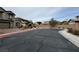View of the community's street surrounded by desert landscaping and well-maintained homes at 3925 Kettle Falls Ave, North Las Vegas, NV 89085