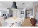 Open-concept dining area with modern light fixture and views into kitchen and living area at 3950 S Sandhill Rd # 132, Las Vegas, NV 89121