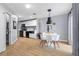 Modern dining area with stylish lighting, wood-look floors, and adjacent kitchen at 3950 S Sandhill Rd # 132, Las Vegas, NV 89121