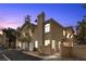 Exterior elevation of a two-story home displaying a gated entrance and mature trees at 3950 S Sandhill Rd # 132, Las Vegas, NV 89121