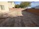 Backyard with a dirt lot and brick perimeter fence, presenting an opportunity for landscaping at 41 Rosa Rosales Ct, North Las Vegas, NV 89031