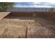 Backyard featuring a dirt lot, brick fence, and partial paver stones at 41 Rosa Rosales Ct, North Las Vegas, NV 89031
