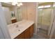 Bright bathroom featuring a single sink vanity and a shower-tub combo with sliding glass doors at 41 Rosa Rosales Ct, North Las Vegas, NV 89031