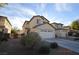 Beige two-story home with a two-car garage and simple desert landscaping at 41 Rosa Rosales Ct, North Las Vegas, NV 89031