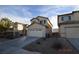 Beige two-story home with an attached two-car garage and concrete driveway at 41 Rosa Rosales Ct, North Las Vegas, NV 89031