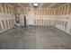 Open garage with ample space, featuring a refrigerator and access door at 41 Rosa Rosales Ct, North Las Vegas, NV 89031